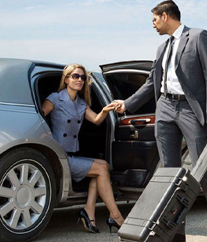 Woman getting a helping hand from a gentlemen getting out of a Limo